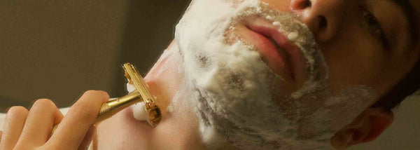 man-shaving-gold-safety-razor