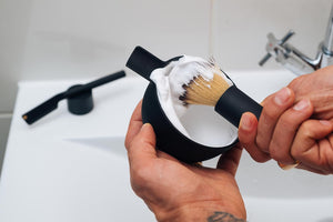 black-shaving-brush-with-bowl-in-hands
